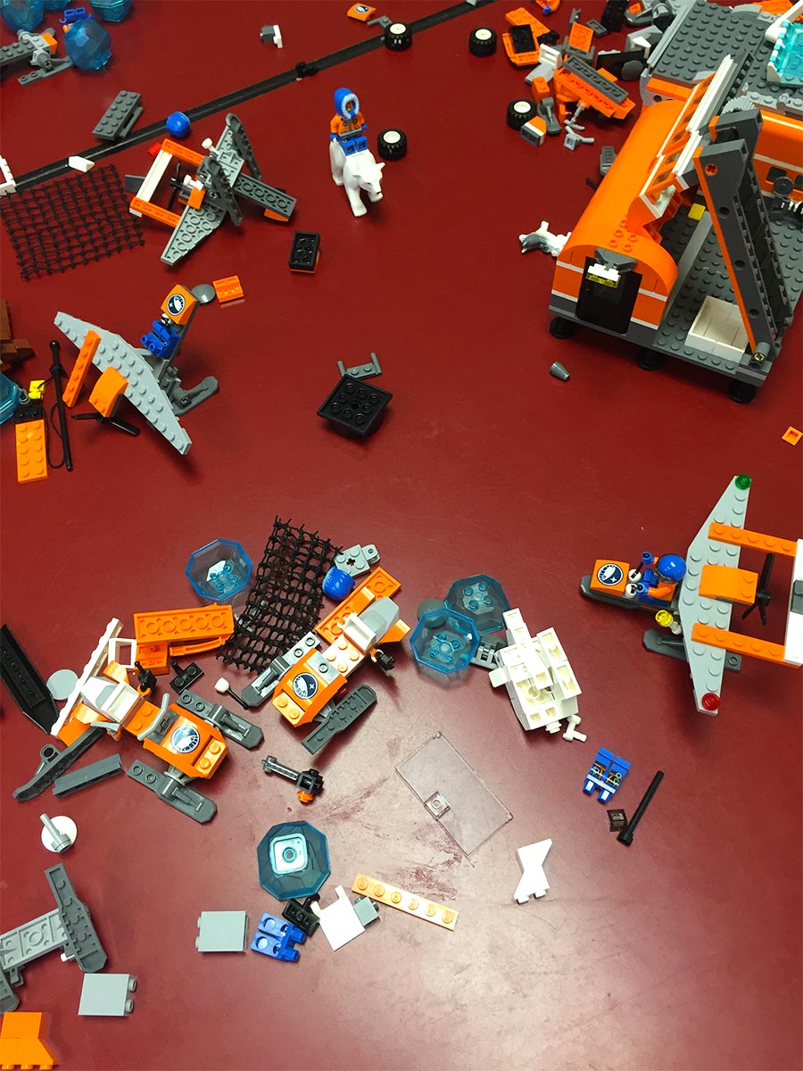 A pile of Legos on the floor of a STEM learning classroom.