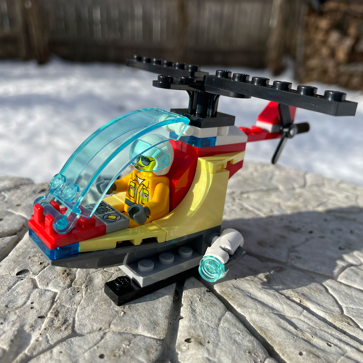A LEGO helicopter with pilot ready to fight wild fires.